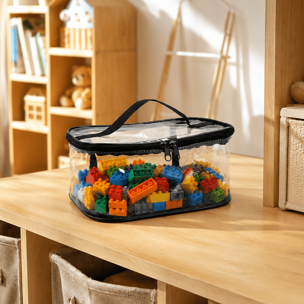 A clear plastic storage organizer bag with a black zipper and handle, filled with colorful toy building blocks, placed on a light wood shelf in a child's room.
